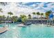 Community pool with a water slide and plenty of lounge chairs at 10175 Peebles St, Orlando, FL 32827