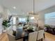 Open concept dining area with a dark wood table and modern chandelier at 10175 Peebles St, Orlando, FL 32827