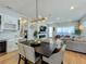 Elegant dining room with dark wood table and modern chandelier at 10175 Peebles St, Orlando, FL 32827