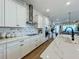 White kitchen with quartz countertops and black appliances at 10175 Peebles St, Orlando, FL 32827