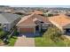 One-story house with a brown roof and a brick driveway at 125 Silver Maple Rd, Groveland, FL 34736