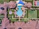 Aerial view of community pool, lawn, and residential buildings at 125 Silver Maple Rd Rd, Groveland, FL 34736