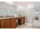 Double vanity bathroom with granite countertops and shower at 125 Silver Maple Rd, Groveland, FL 34736