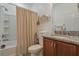 Clean bathroom with granite vanity, tub shower combination, and neutral decor at 125 Silver Maple Rd, Groveland, FL 34736