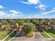 Grand entrance to the Trilogy community with lush landscaping and a gated entry at 125 Silver Maple Rd Rd, Groveland, FL 34736