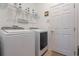 Laundry room with washer, dryer, and shelving at 125 Silver Maple Rd, Groveland, FL 34736