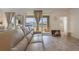 Living room with beige couch and sliding glass doors at 125 Silver Maple Rd, Groveland, FL 34736