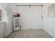 White room with a barn door, tiled floors, and a white cabinet at 125 Silver Maple Rd, Groveland, FL 34736