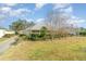 View of the home's exterior, highlighting the backyard and landscaping at 1501 Edgewater Dr, Mount Dora, FL 32757