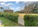 Landscaped backyard with a white gate leading to a green space at 1501 Edgewater Dr, Mount Dora, FL 32757