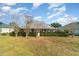 House exterior view, showcasing a large backyard and lush landscaping at 1501 Edgewater Dr, Mount Dora, FL 32757