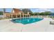 Community pool with surrounding lounge chairs and a pool house at 1501 Edgewater Dr, Mount Dora, FL 32757