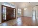 Inviting entryway with hardwood floors and a large front door at 1501 Edgewater Dr, Mount Dora, FL 32757