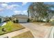 House exterior showcasing a garage and well-maintained landscaping at 1501 Edgewater Dr, Mount Dora, FL 32757