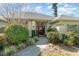 Inviting front entry with a double door, lush landscaping, and a brick walkway at 1501 Edgewater Dr, Mount Dora, FL 32757