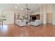 Living room with hardwood floors, built-in entertainment center, and a ceiling fan at 1501 Edgewater Dr, Mount Dora, FL 32757