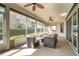 Relaxing screened porch with seating and ceiling fans at 1501 Edgewater Dr, Mount Dora, FL 32757