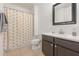 Cheerful bathroom with a shower/tub combo and dark vanity at 1569 Tamarind Rd, Davenport, FL 33896