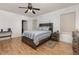 Main bedroom with a wooden bed frame and plenty of natural light at 1569 Tamarind Rd, Davenport, FL 33896