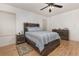 Spacious bedroom with wood-look floors and a striped comforter at 1569 Tamarind Rd, Davenport, FL 33896