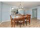 Dining room with wood table and chairs, open to kitchen at 1569 Tamarind Rd, Davenport, FL 33896