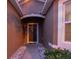 Front entry with a dark-brown door and stone pathway at 1569 Tamarind Rd, Davenport, FL 33896