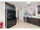 Black stainless steel appliances and dark brown cabinets in this kitchen at 1569 Tamarind Rd, Davenport, FL 33896