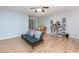 Living room with hardwood floors, comfy seating, and built-in shelving at 1569 Tamarind Rd, Davenport, FL 33896