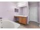 Bathroom with double vanity, bathtub, and light wood cabinets at 1605 S Mary St, Eustis, FL 32726