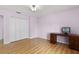 Bedroom with wood desk, double door closet, and laminate floors at 1605 S Mary St, Eustis, FL 32726