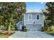 Two-story house with gray siding, attached garage, and landscaping at 1605 S Mary St, Eustis, FL 32726