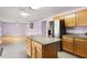 Kitchen with island, granite countertops, and wood cabinets at 1605 S Mary St, Eustis, FL 32726