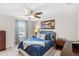 Bright bedroom featuring a full bed, and ceiling fan at 16133 Pebble Bluff Loop, Winter Garden, FL 34787