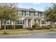 Two story townhome with green exterior, landscaping, and walkway at 16133 Pebble Bluff Loop, Winter Garden, FL 34787