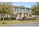 Two story townhome with green exterior, landscaping, and a two-car garage at 16133 Pebble Bluff Loop, Winter Garden, FL 34787