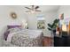 Cozy bedroom with floral bedding and ceiling fan at 16926 Reseda Aly, Winter Garden, FL 34787