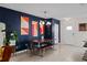 Mid-century modern dining area with a wooden table and blue accent wall at 16926 Reseda Aly, Winter Garden, FL 34787