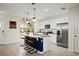 Modern kitchen with white cabinets, granite island, and stainless steel appliances at 16926 Reseda Aly, Winter Garden, FL 34787