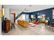 Modern living room with a mustard yellow couch and blue accent wall at 16926 Reseda Aly, Winter Garden, FL 34787