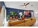 Bright and airy living room featuring a comfortable sectional sofa and a large TV at 16926 Reseda Aly, Winter Garden, FL 34787