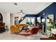 Mid-century modern living room with stylish furnishings and a view of the backyard at 16926 Reseda Aly, Winter Garden, FL 34787