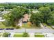 Aerial view of a house under construction, surrounded by lush trees and other homes at 1705 Geigel Ave, Orlando, FL 32806