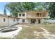 Rear view of a house under construction with an old pool and exposed framing at 1705 Geigel Ave, Orlando, FL 32806