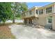 House under renovation, showing the rear exterior with exposed framing and a concrete patio at 1705 Geigel Ave, Orlando, FL 32806