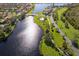 Aerial view of the community with lake and walking paths at 181 Tall Pines Pass, Kissimmee, FL 34759