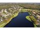 Aerial view of community with lake and golf course at 181 Tall Pines Pass, Kissimmee, FL 34759