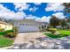 House exterior with a white two-car garage and brick paver driveway at 181 Tall Pines Pass, Kissimmee, FL 34759