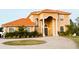 Two-story house with orange tile roof, columns, and landscaped yard at 19229 E Peabody St, Orlando, FL 32833