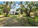 Large backyard with mature trees and open space at 208 S Main Ave, Minneola, FL 34715