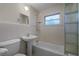 Clean bathroom with shower/tub combo and glass block feature at 208 S Main Ave, Minneola, FL 34715